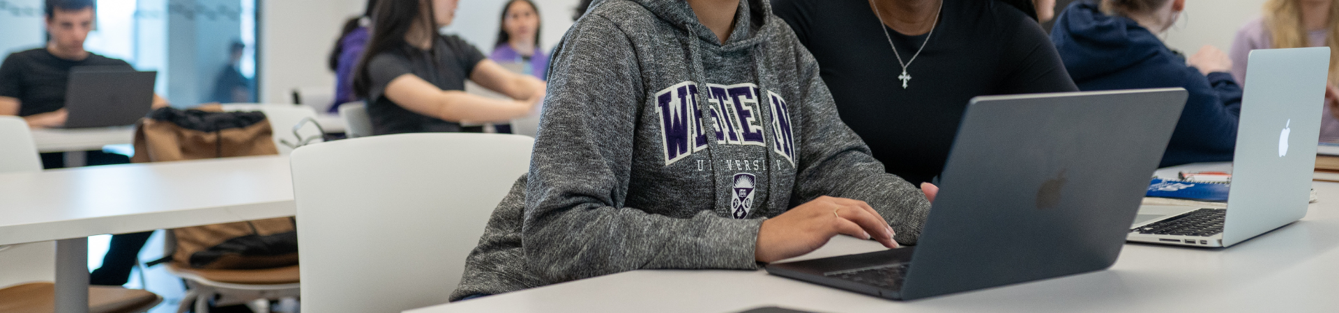 western students working on laptop