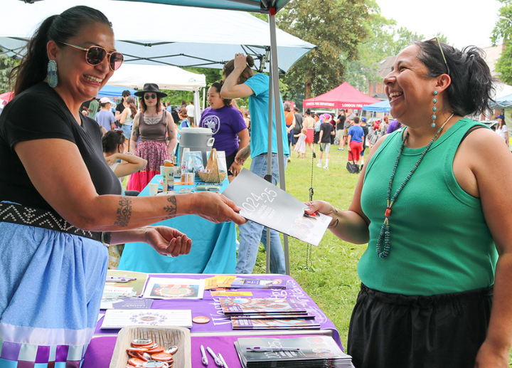handing out annual progress reports to visitors